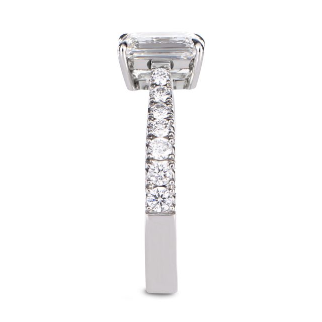 Emerald cut engagement ring in platinum with round white diamonds