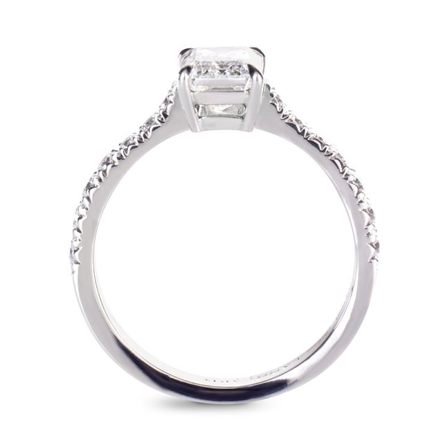 Emerald cut engagement ring in platinum with round white diamonds