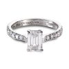 Emerald cut engagement ring in platinum with round white diamonds