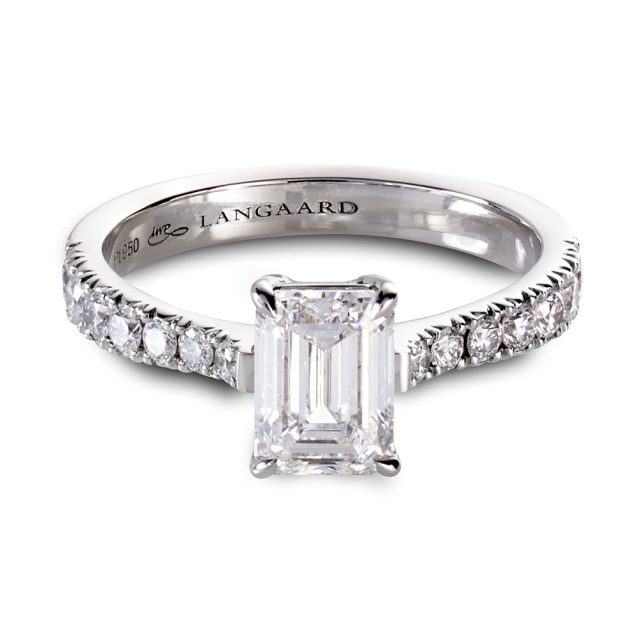 Emerald cut engagement ring in platinum with round white diamonds